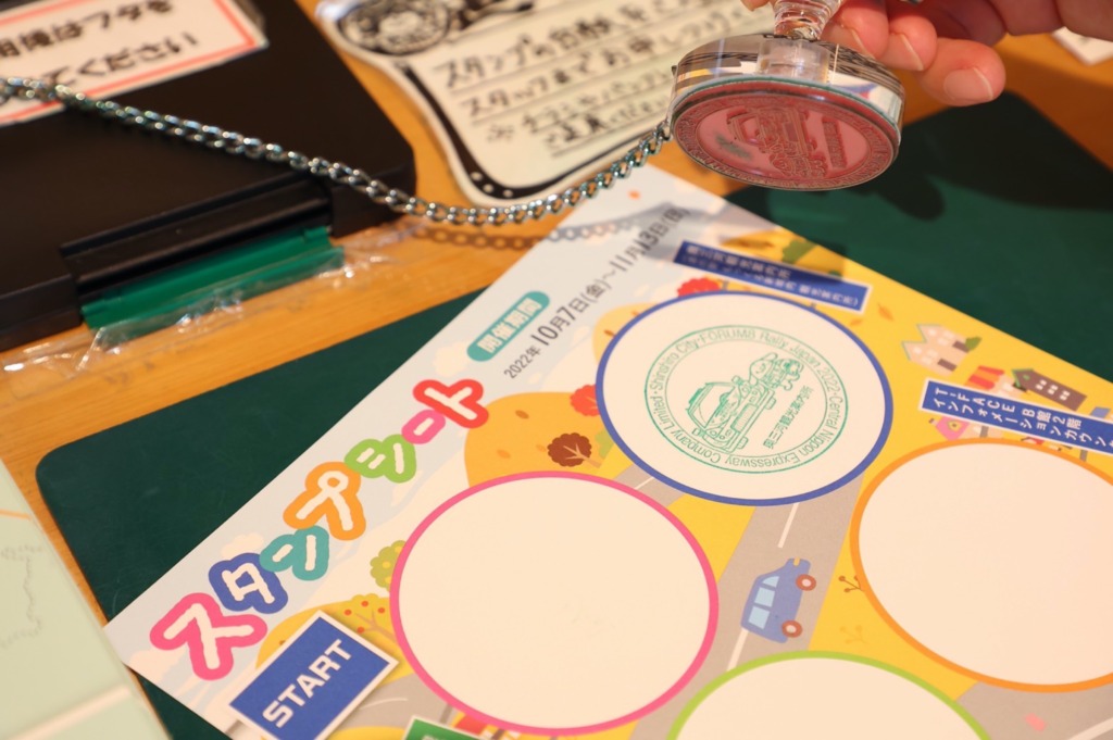 A traveler stamping their sheet at a Japanese stamp rally — each unique design turns the journey into a memorable adventure."